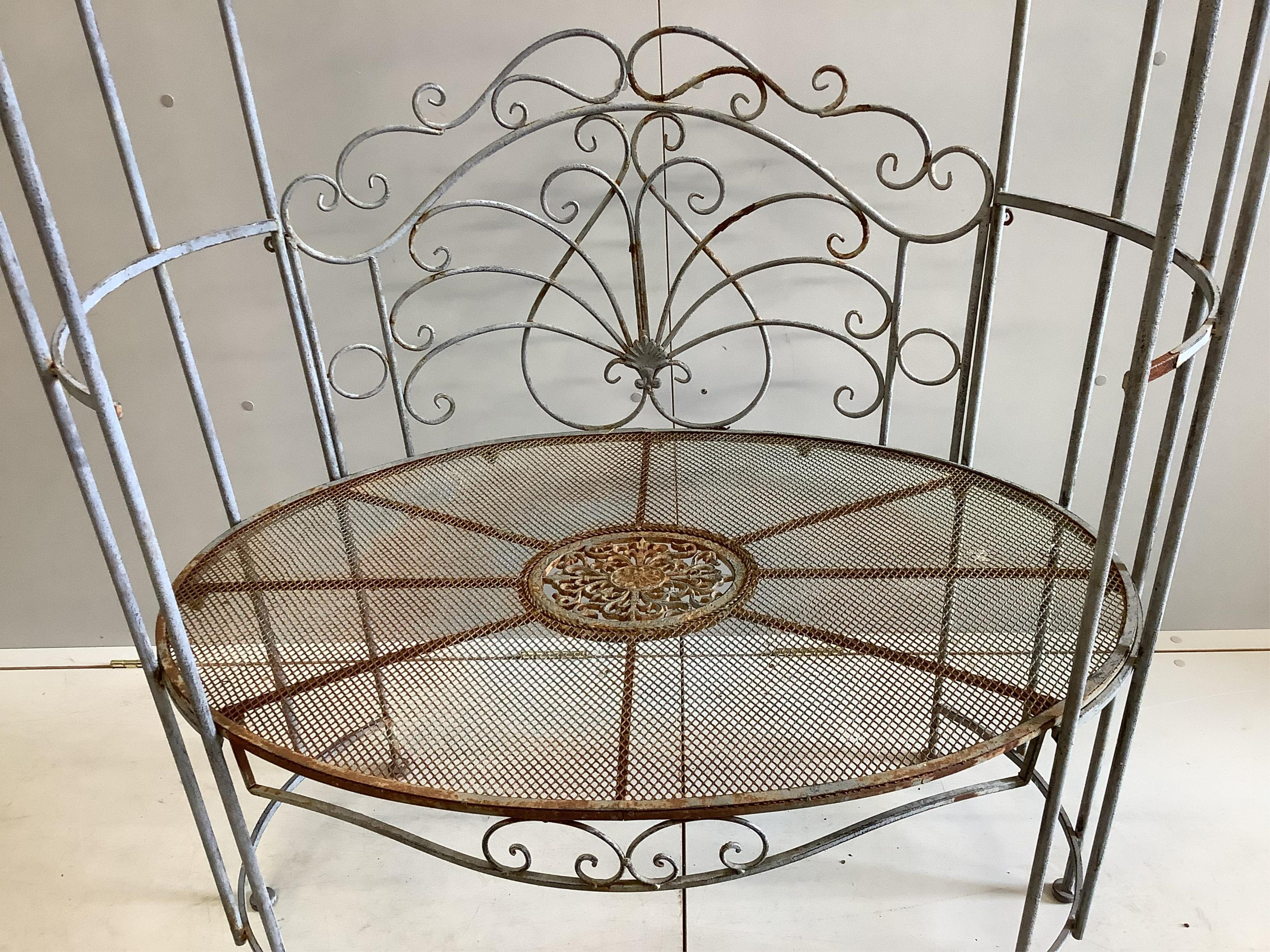 A metal garden arbour seat, width 105cm, depth 64cm, height 194cm. Condition - fair